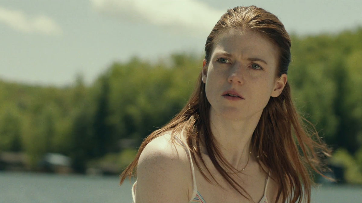 Rose Leslie as Bea looking to the ditance with an expression of curiosity in Honeymoon.