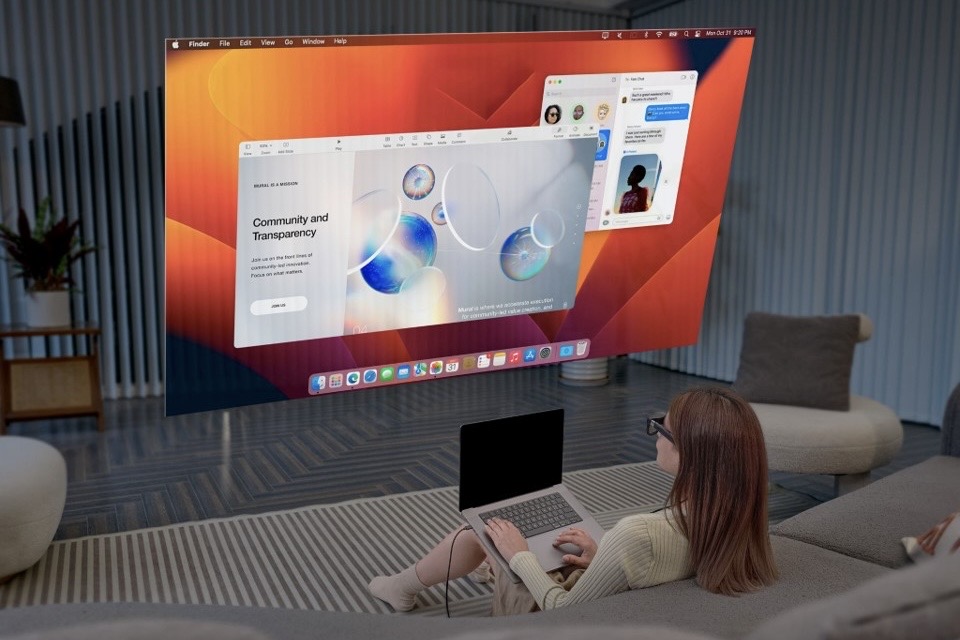 Virtual screens graphically shown in front of a woman on a couch.