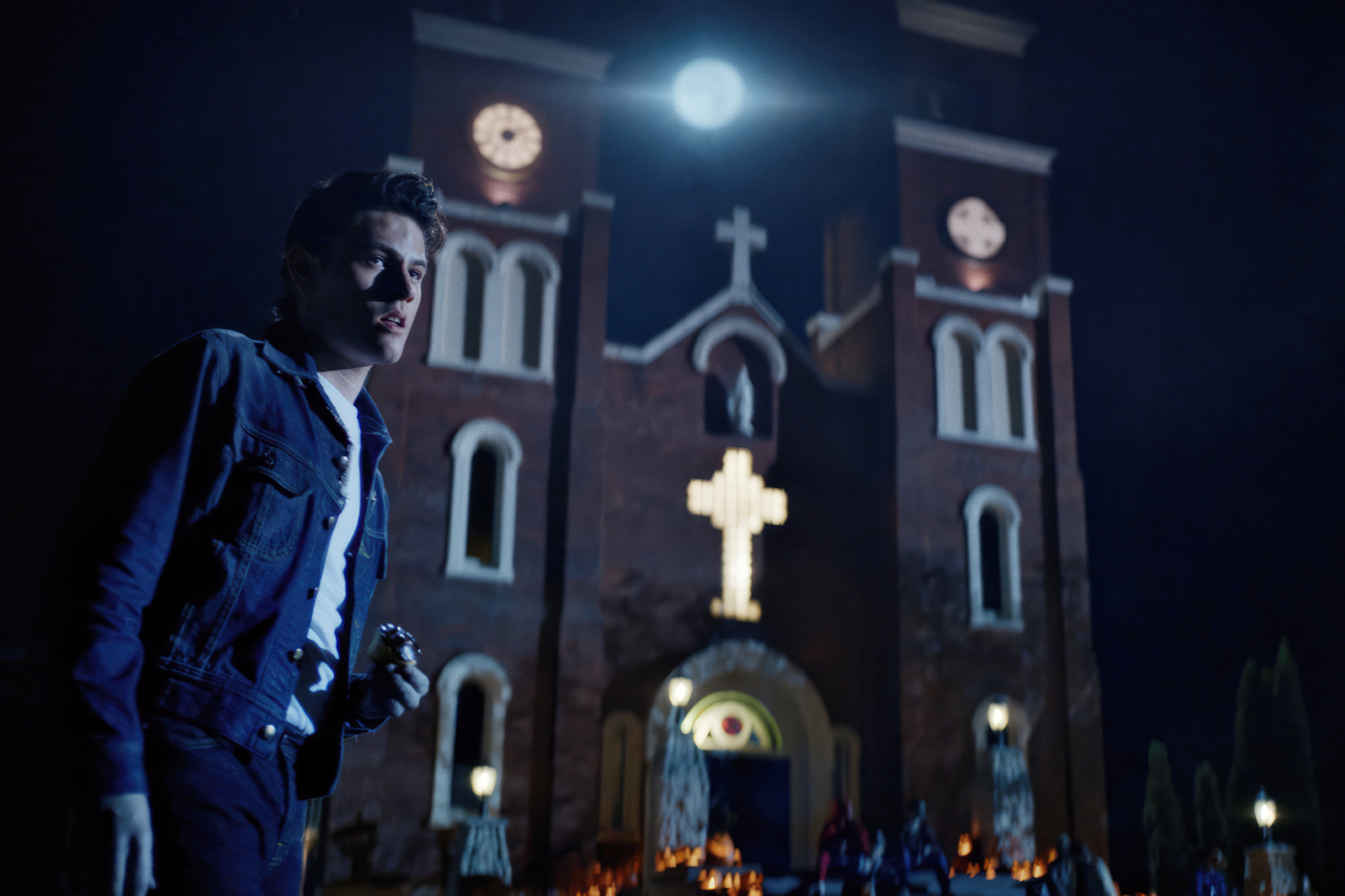 Richie stands near a church in Dark Harvest.