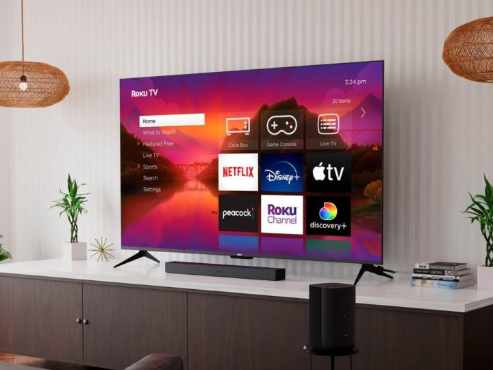 A Roku 75-inch Class Plus Series QLED 4K Smart Roku TV hanging on the wall.