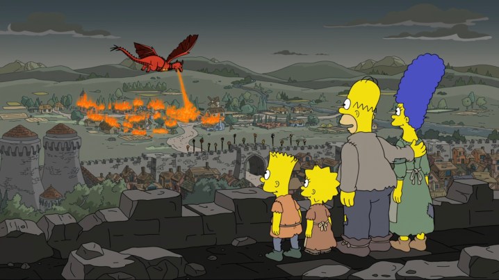Los Simpson viendo a un dragón incendiar Springfieldia en "Los Simpson".