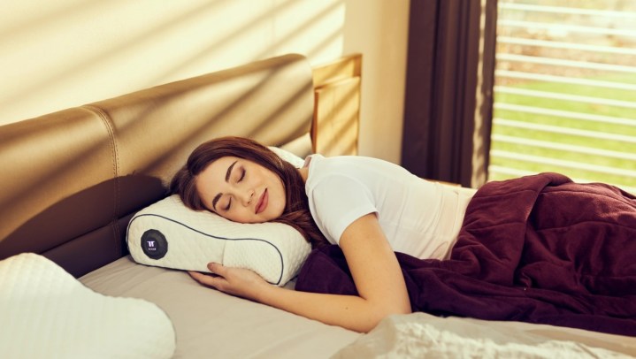 A person sleeping on the Tesla Smart Pillow.