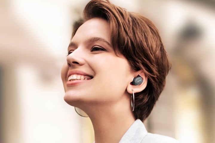 Woman wearing Earfun Free Pro 3 wireless noise-canceling earbuds.