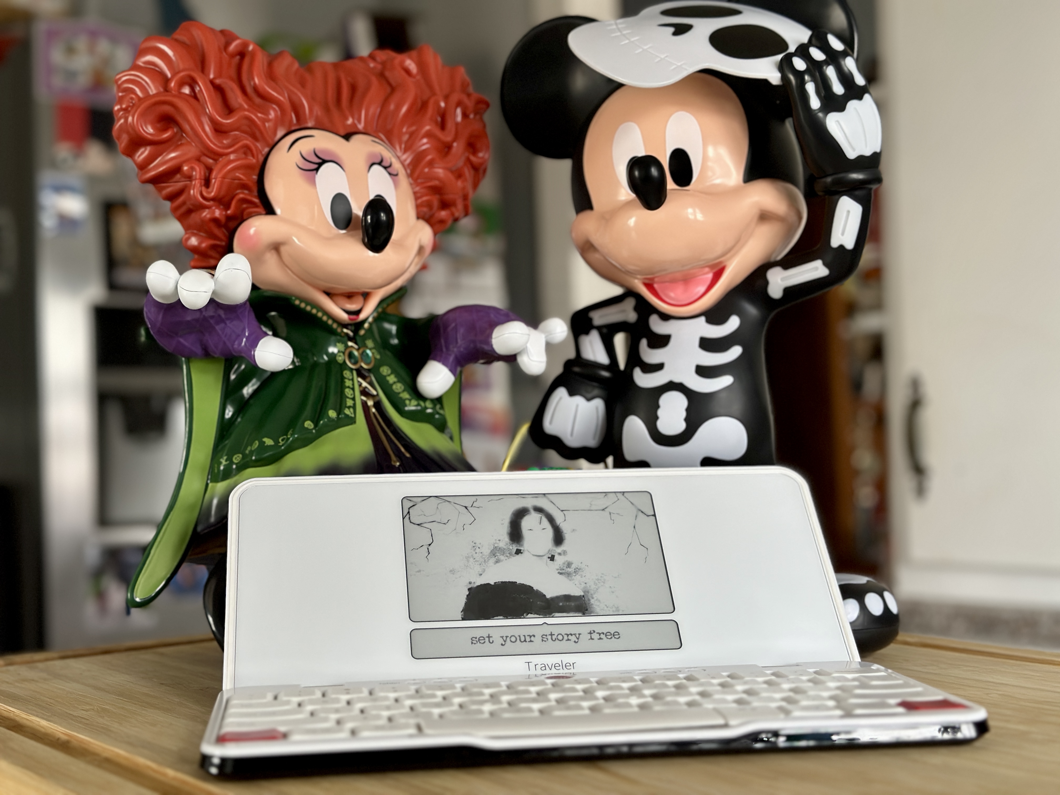 Freewrite Traveler open on screensaver with Disney Halloween figures.