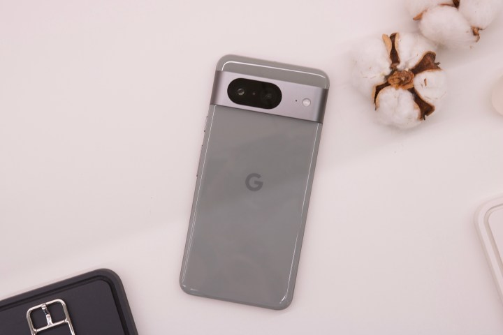 The Google Pixel 8 laying face-down on a table.