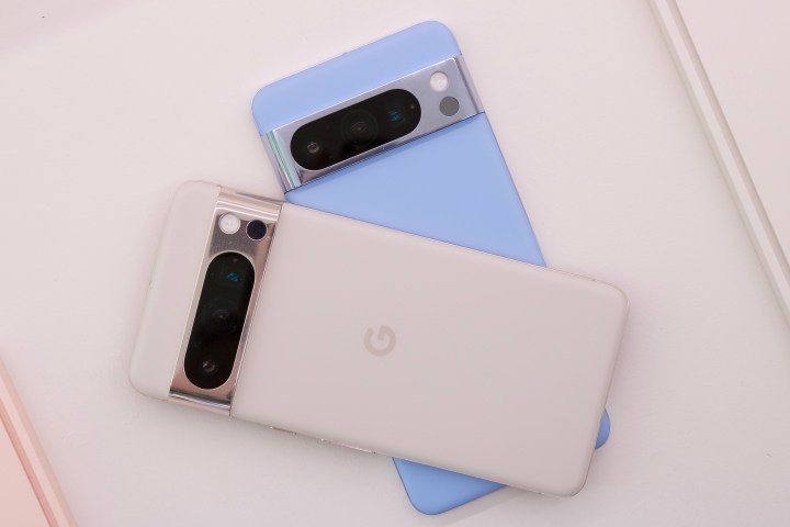 Two Pixel 8 Pro smartphones laying on top of each other.