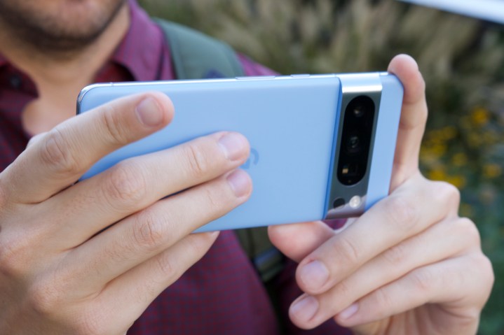A person holding the Google Pixel 8 Pro horizontally.