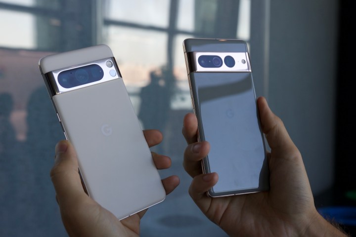 The Google Pixel 8 Pro and Google Pixel 7 Pro being held next to each other.