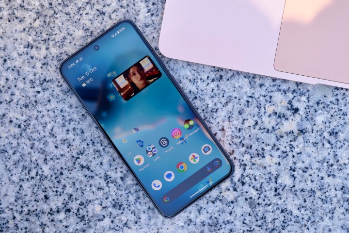 The Google Pixel 8 on a table showing the screen.
