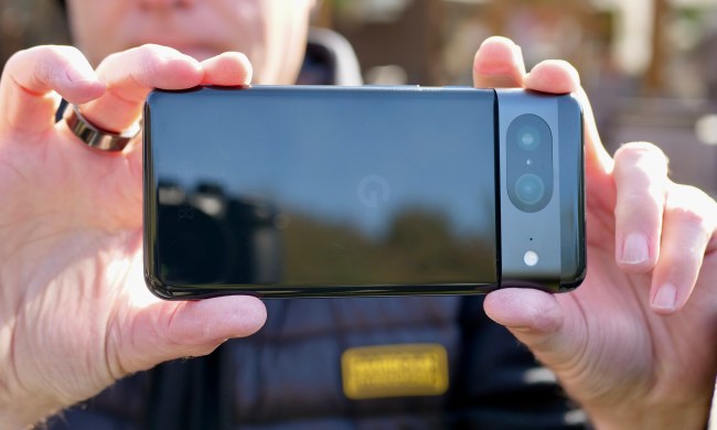A person taking a photo with the Google Pixel 8.