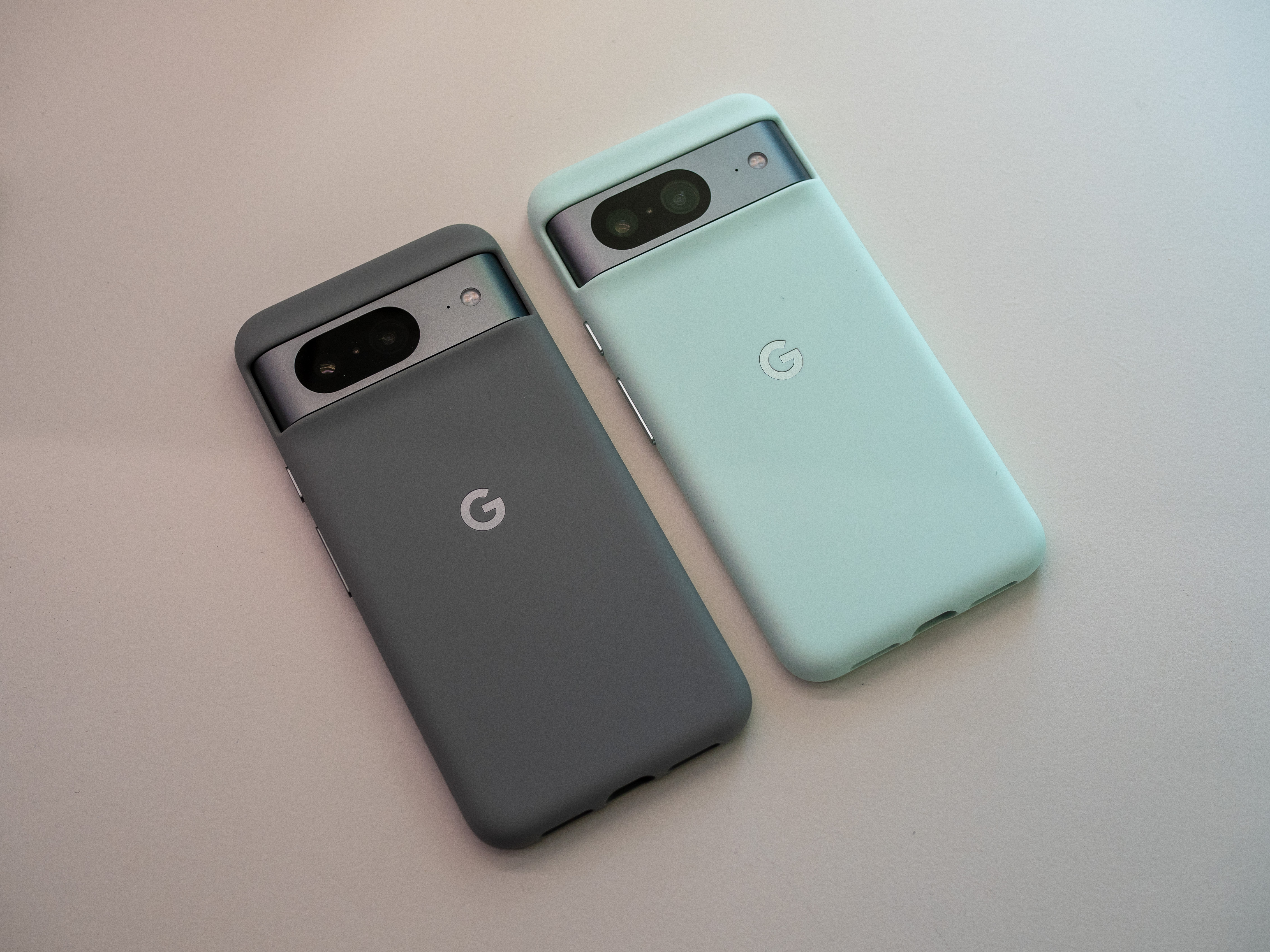 Google Pixel 8 in two different case colors.