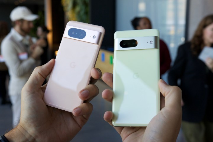 The Google Pixel 8 and Google Pixel 7 being held next to each other.
