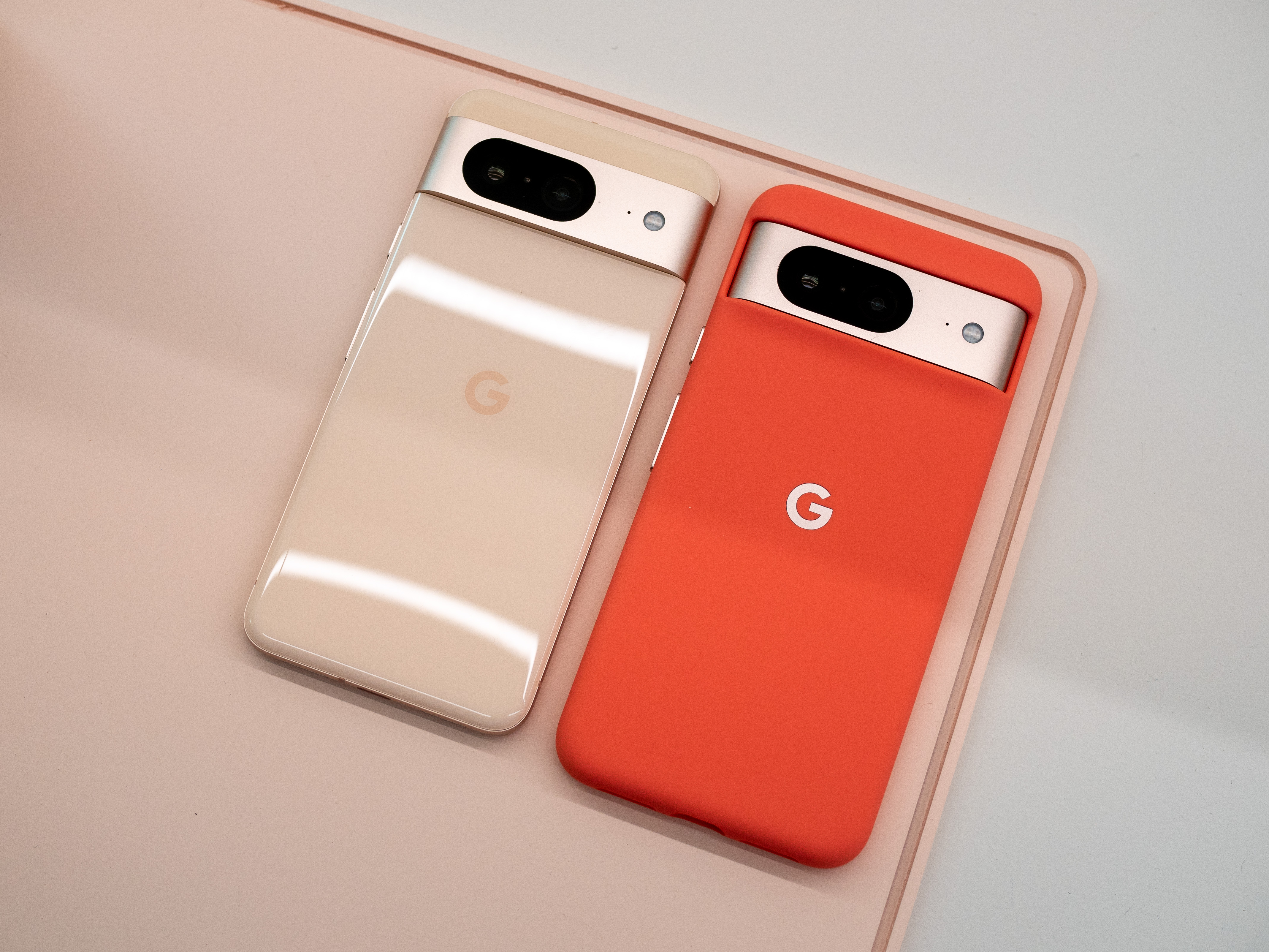 Google Pixel 8 in pink, with and without a case.