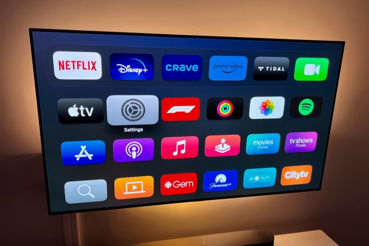 The Apple TV main menu showing the Settings app highlighted.