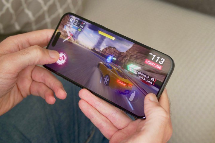 A person playing a game on the Apple iPhone 15 Plus.