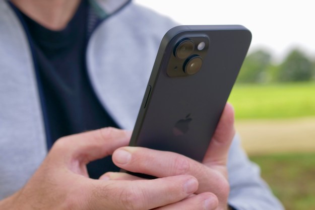 A person holding the Apple iPhone 15 Plus, showing the camera.