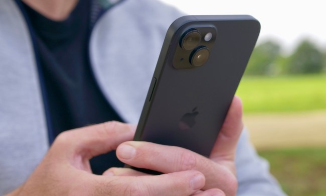 A person holding the Apple iPhone 15 Plus, showing the camera.