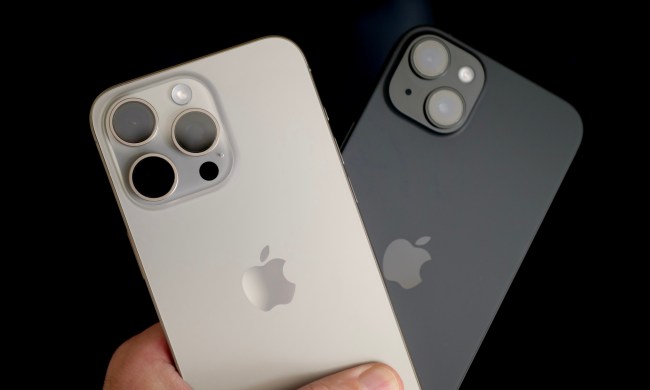 A person holding the Apple iPhone 15 Plus and Apple iPhone 15 Pro Max.
