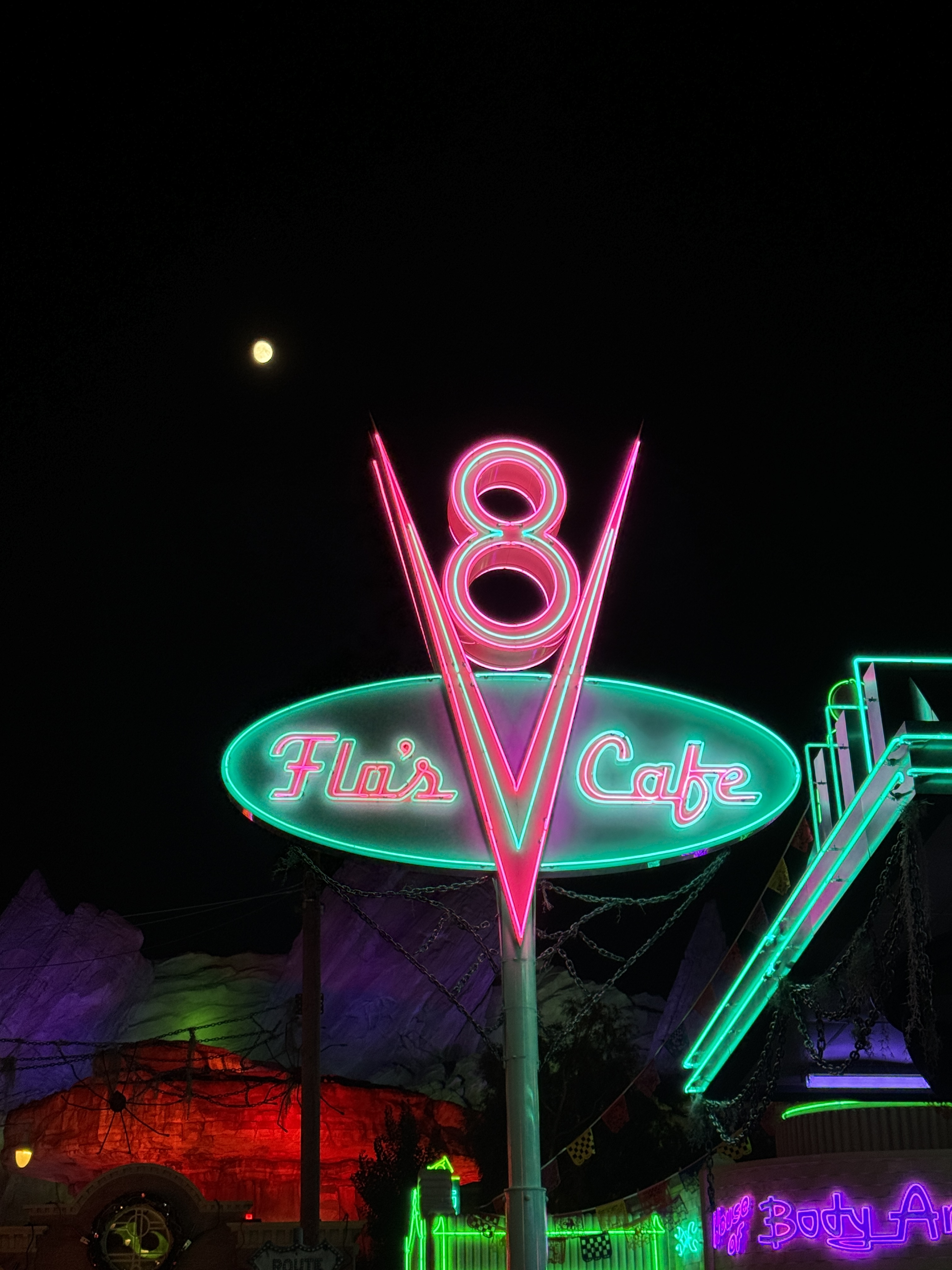Closeup of Flo's V8 Cafe neon sign taken with iPhone 15 Pro telephoto camera.