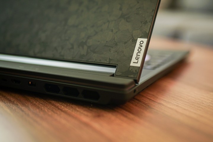 A closeup of the Lenovo logo on the lid of a laptop.