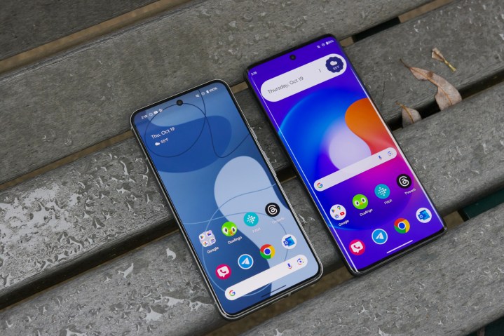 The Google Pixel 8 and Motorola Edge (2023) laying on a bench with their screens turned on.