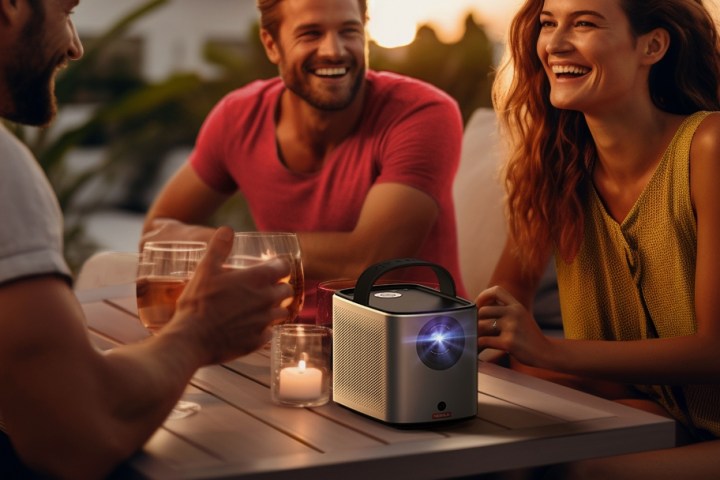 The Nebula Mars 3 Air portable projector on a coffee table outdoors.