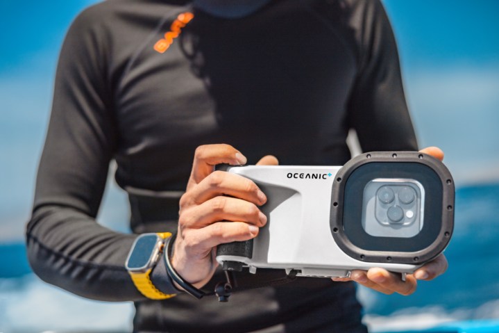 A person holding the Oceanic+ Dive Housing.
