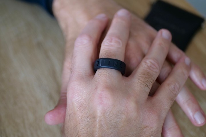 A person wearing the Oura Ring in the Equinox Ring Cover.