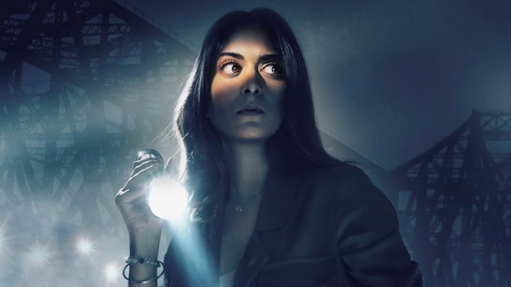 A woman in the dark with a flashlight in a scene from Amazon Prime Video series P.I. Meena.