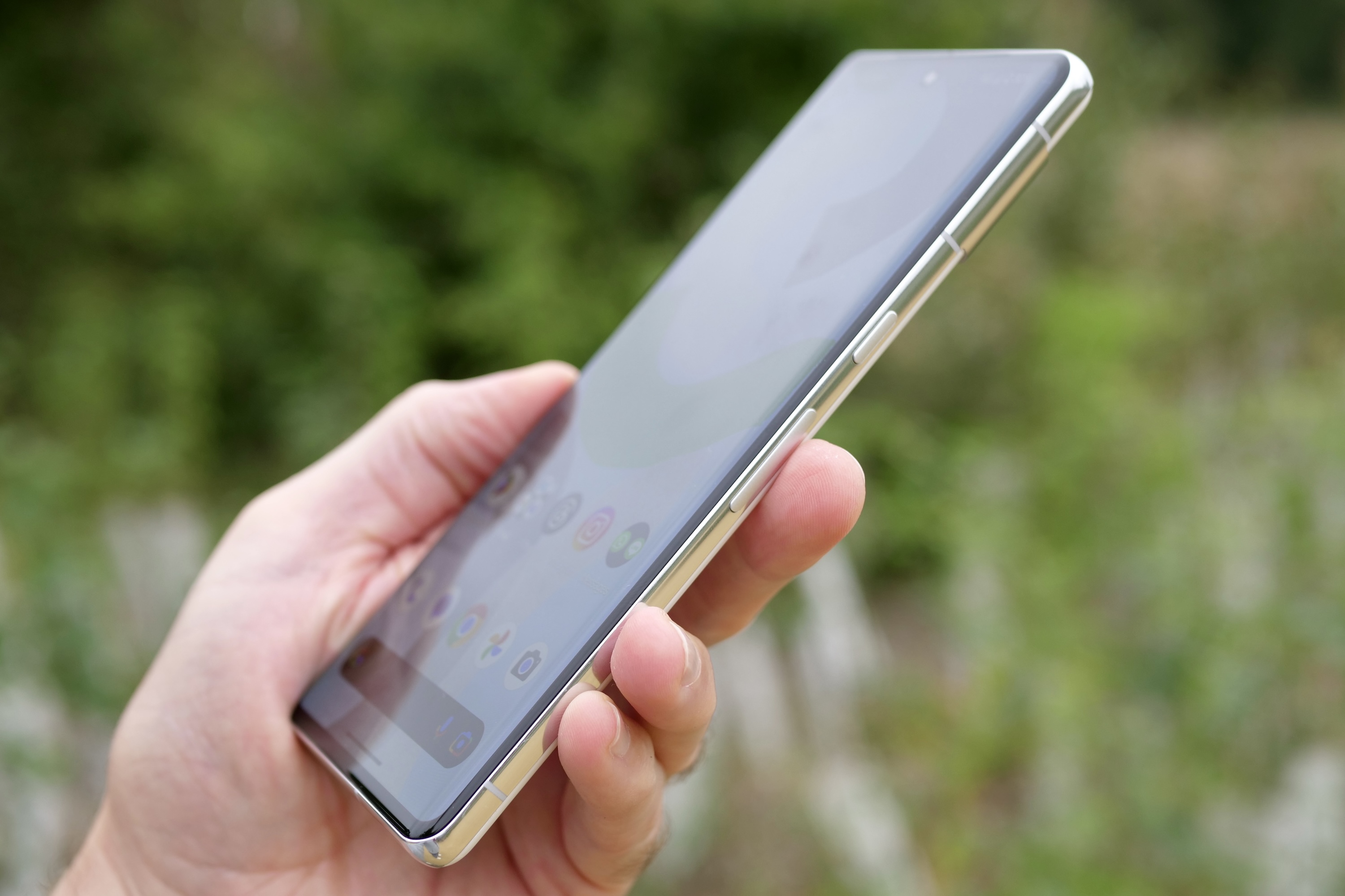 A person holding the Google Pixel 7 Pro, seen from the side.