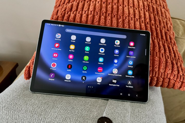 The Samsung Galaxy Tab S9 FE+ laying on pillows.