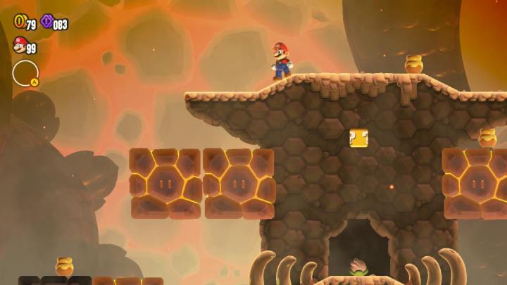 Mario is standing near some hot blocks in Super Mario Bros. Wonder.