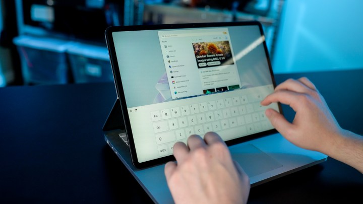 Someone typing on the Surface Laptop Studio 2's touchscreen.
