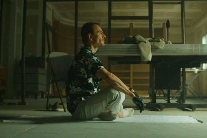 A man sits on a floor in The Killer.