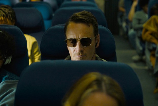 A man sits on a plane in The Killer.