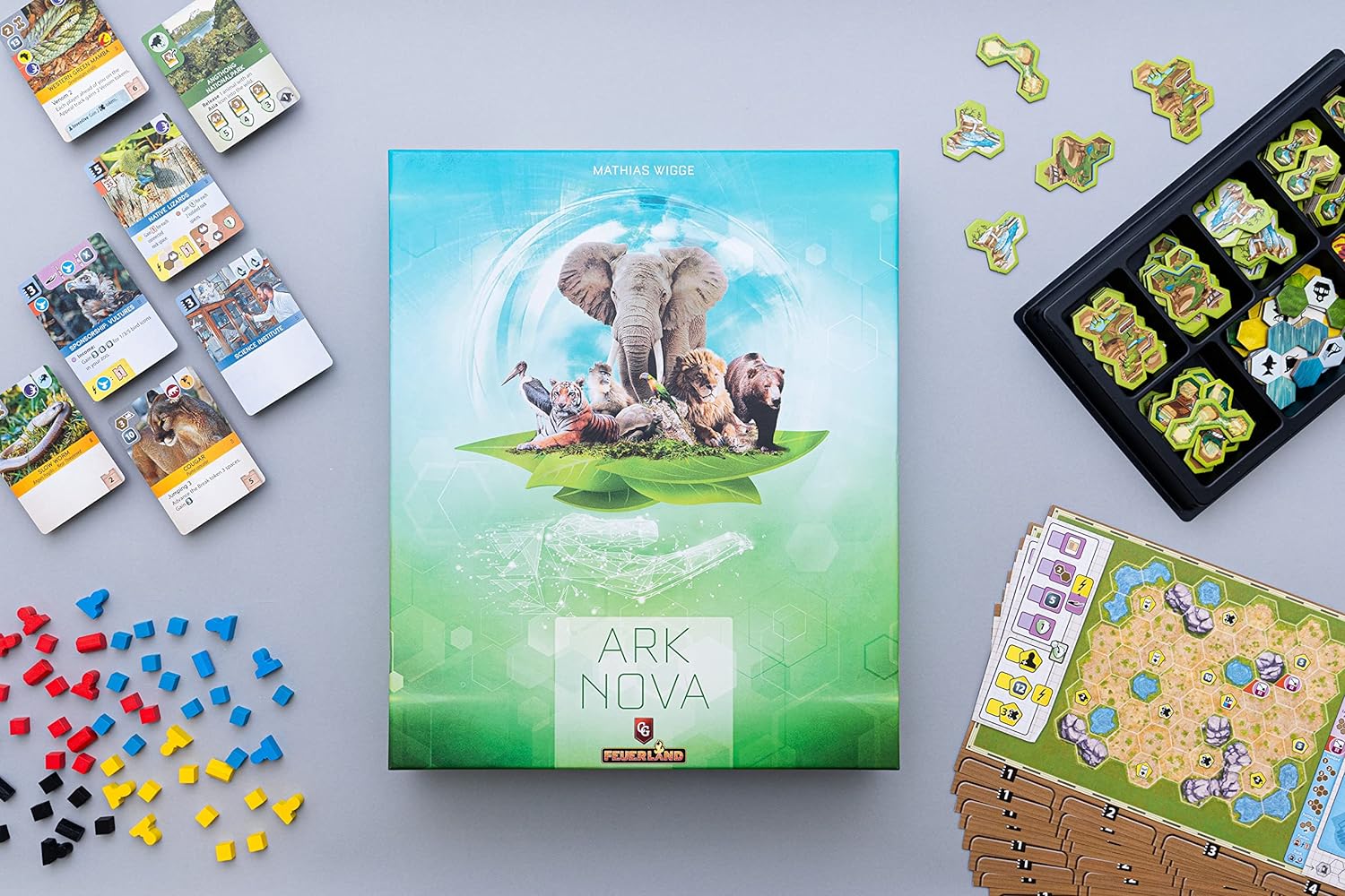The Ark Nova board game box, surrounded by components.