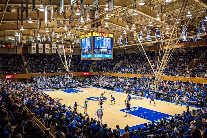 Basketball players on the court at Cameron Indoor Stadium.