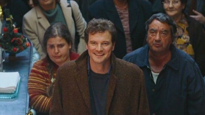Colin Firth as Jamie smiling and looking up in Love Actually.