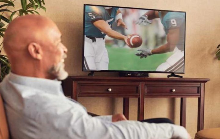 Man watching NFL package on Dish Network.