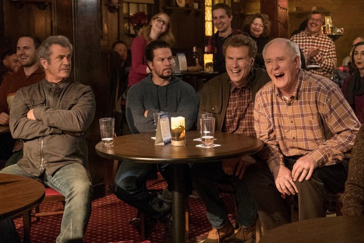 Four men sit at a table and laugh in Daddy's Home 2.
