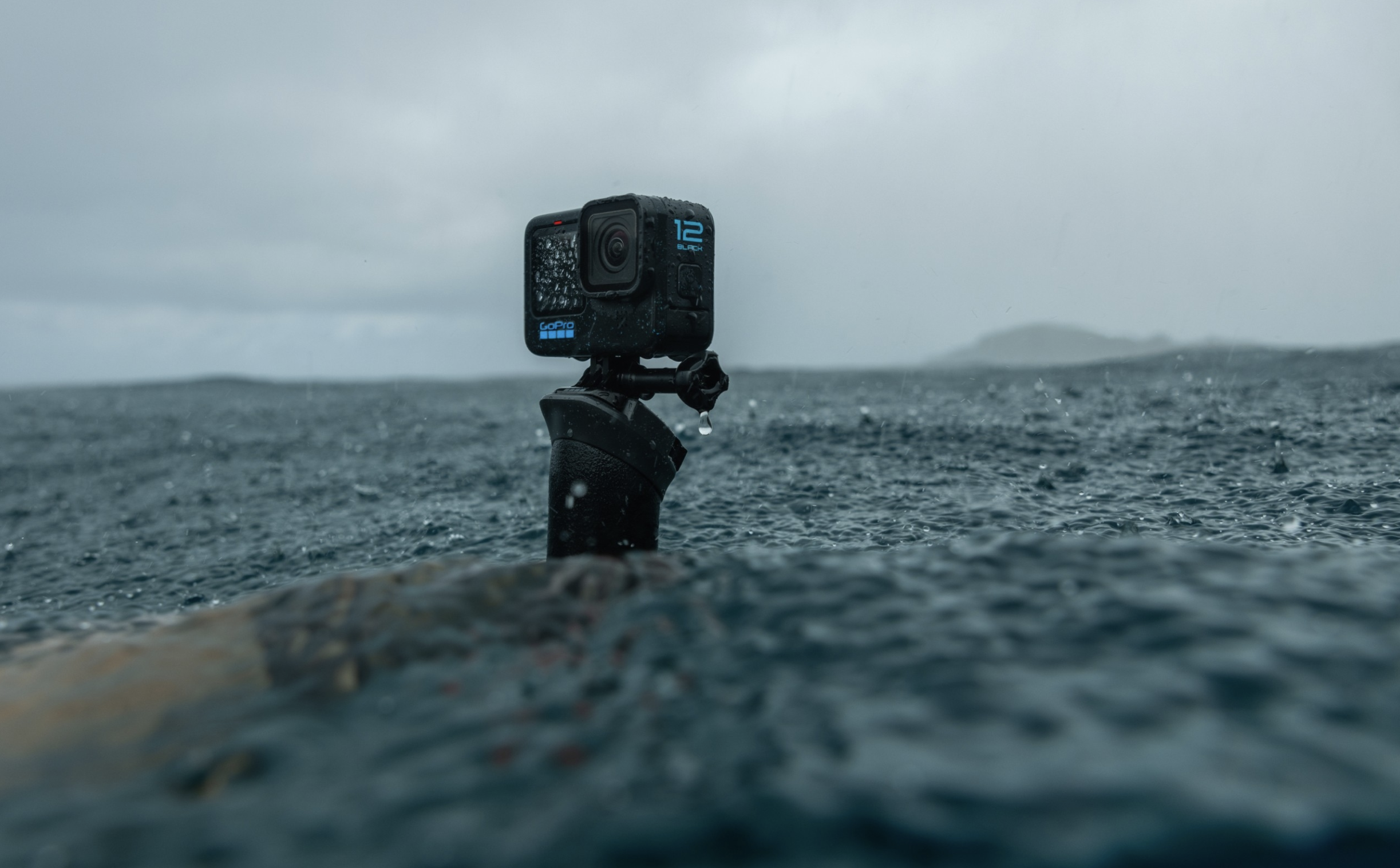 The GoPro Hero 12 action camera recording water on a beach.