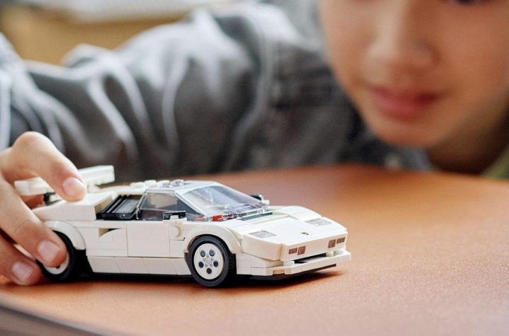A child playing with the Lamborghini Countach Lego set.
