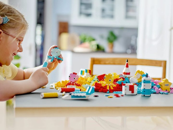 A girl plays with the Lego Classic Creative Color Fun pack.