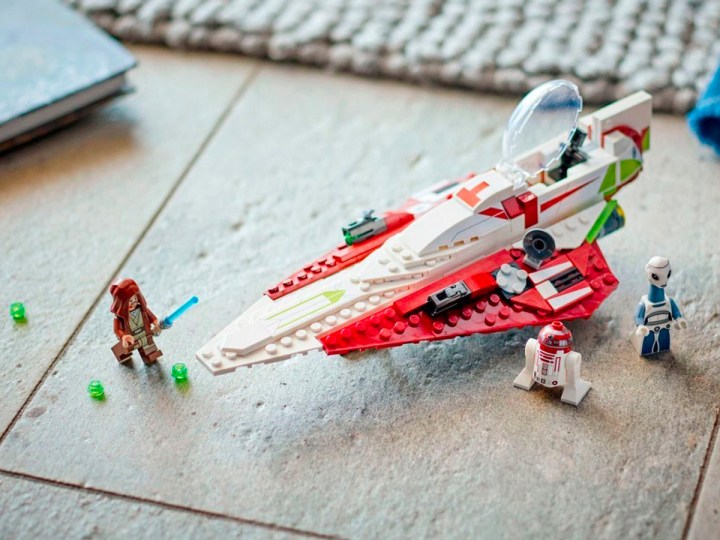 Собранный на полу звездный истребитель-джедай Оби-Вана Кеноби из Lego Star Wars.