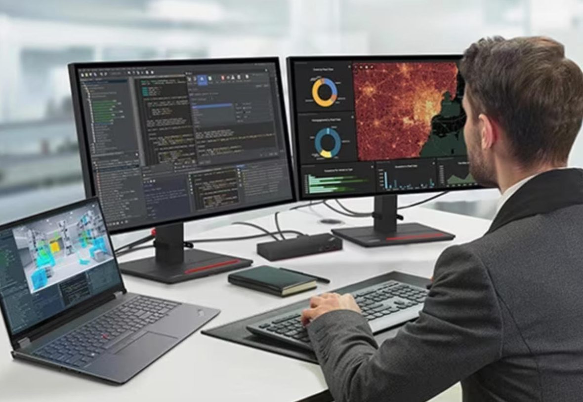 مردی روی یک ایستگاه کاری سیار Lenovo ThinkPad P16 کار می‌کند که روی یک میز با دو نمایشگر خارجی متصل است.
