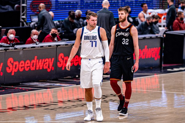 Luka Doncic walks down the basketball court next to Dean Wade.