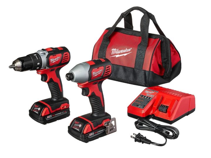 A set of Milwaukee M18 power tools with batteries, drill and impact driver set.