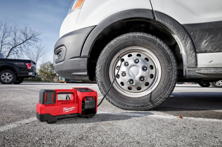 Milwaukee M18 Inflator connected to a van tire.