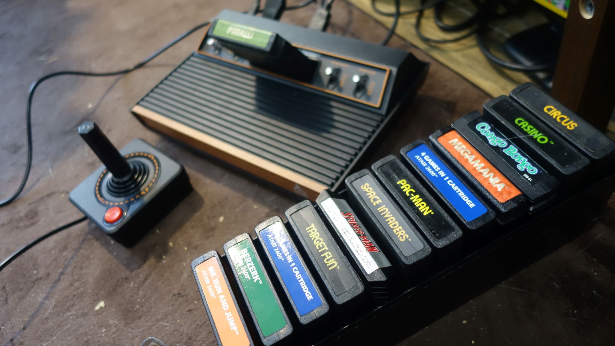 A case full of Atari games sits next to an Atari 2600+.