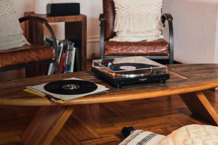 The Audio-Technica AT-LP60BT-USB turntable on a coffee table.
